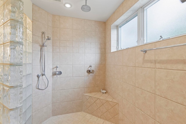 bathroom with a tile shower