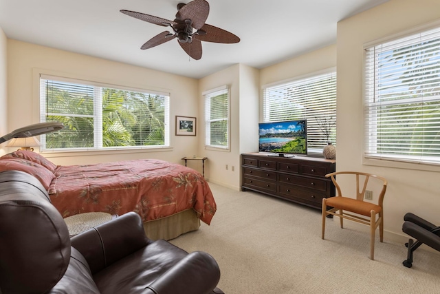 bedroom featuring light carpet and ceiling fan