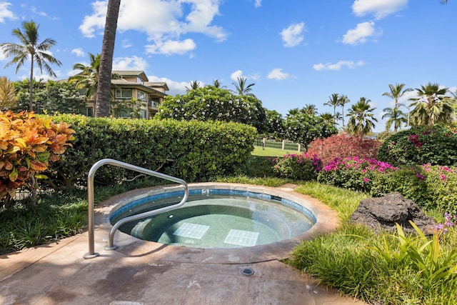 view of swimming pool with an in ground hot tub