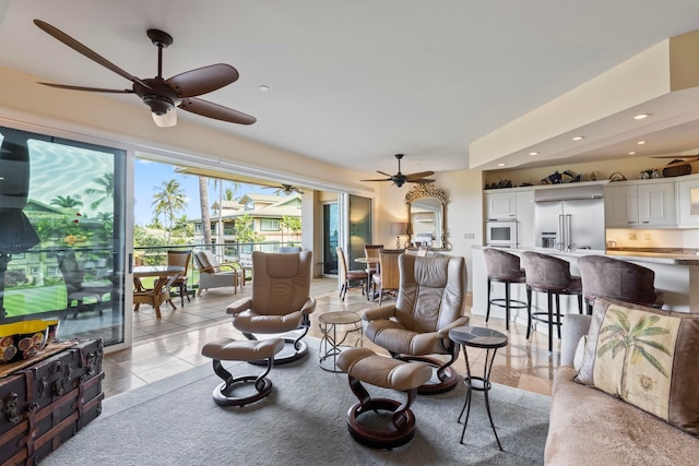 tiled living room featuring ceiling fan