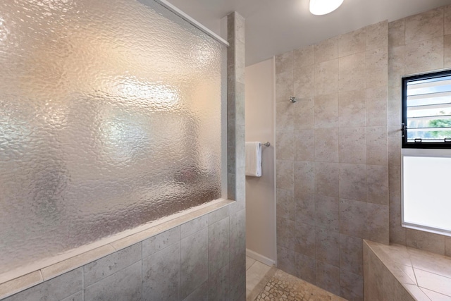 bathroom with a tile shower