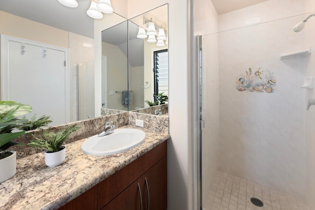 bathroom featuring walk in shower and vanity