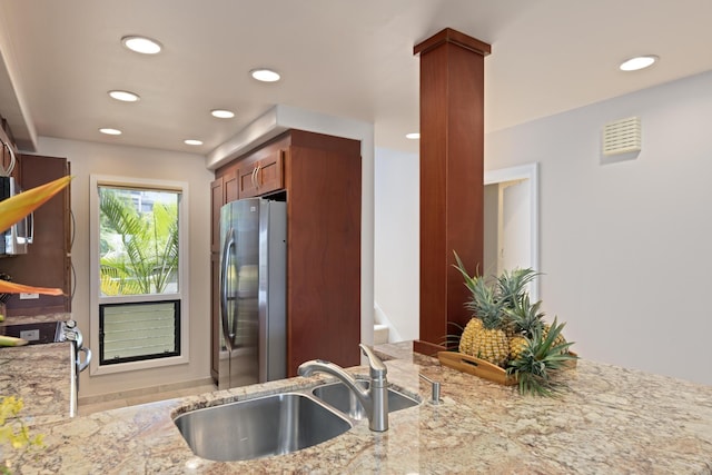100 Ridge Rd Unit 723, Lahaina, HI 96761 - kitchen featuring freestanding refrigerator, light stone counters, recessed lighting, and brown cabinetry