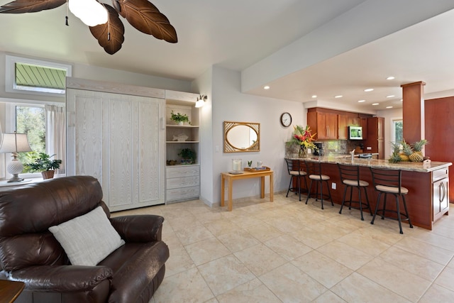 tiled living room featuring ceiling fan