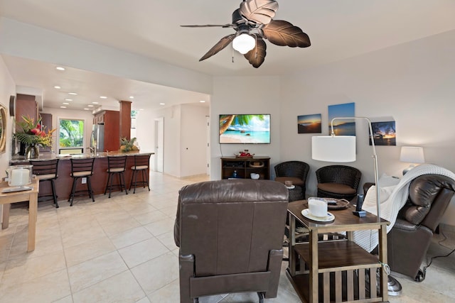 living room featuring light tile patterned floors and ceiling fan