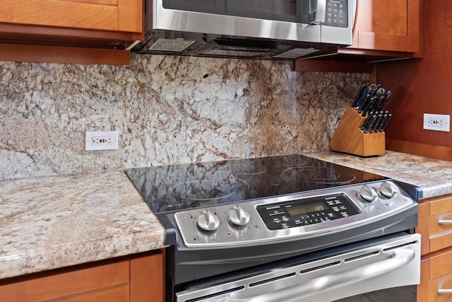 100 Ridge Rd Unit 723, Lahaina, HI 96761 - kitchen with stainless steel appliances, backsplash, light countertops, and brown cabinetry