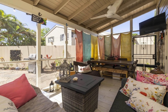 sunroom / solarium featuring an outdoor hangout area, beam ceiling, and ceiling fan
