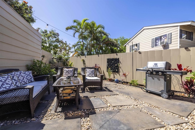 view of patio / terrace with a fenced backyard, an outdoor hangout area, and a grill
