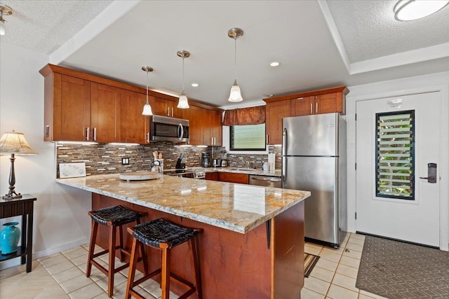 kitchen featuring light stone countertops, appliances with stainless steel finishes, backsplash, hanging light fixtures, and light tile patterned floors