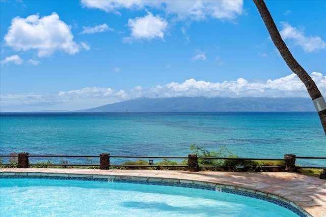 view of pool with a water and mountain view