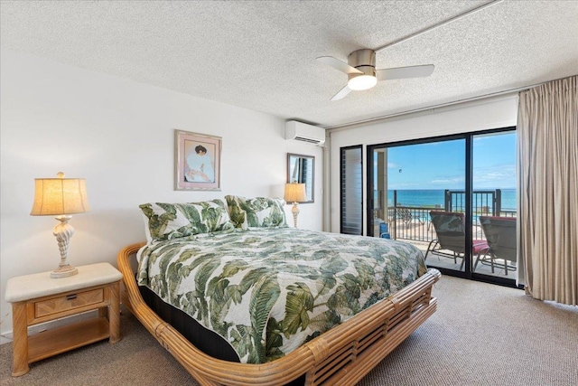 bedroom with a textured ceiling, a water view, carpet, access to outside, and ceiling fan