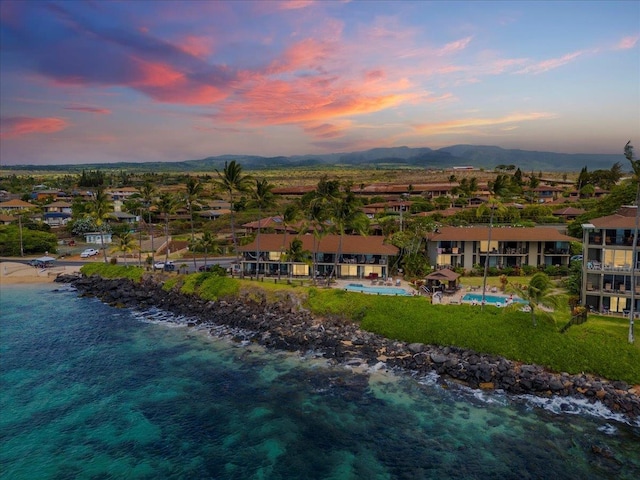 aerial view at dusk with a water view