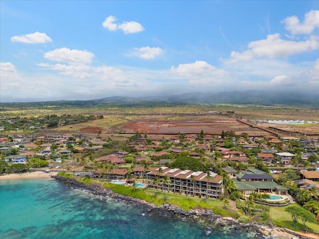 aerial view with a water view and a beach view