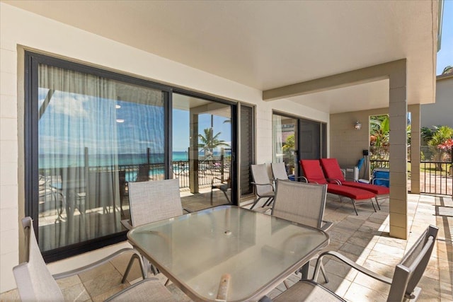 view of patio with a balcony and a water view