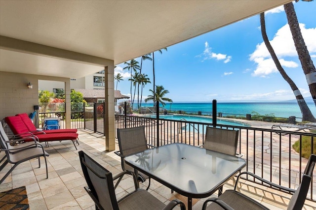 view of patio with a balcony and a water view