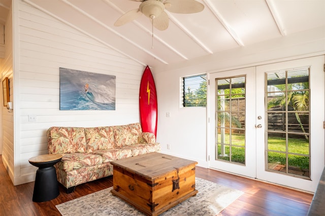 living room with french doors, lofted ceiling with beams, dark hardwood / wood-style floors, and wood walls