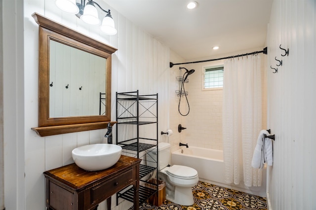 full bathroom with toilet, shower / bathtub combination with curtain, and sink