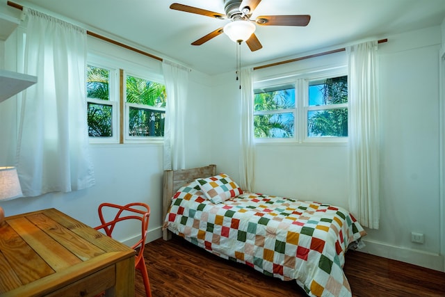 bedroom featuring multiple windows, ceiling fan, and dark hardwood / wood-style floors