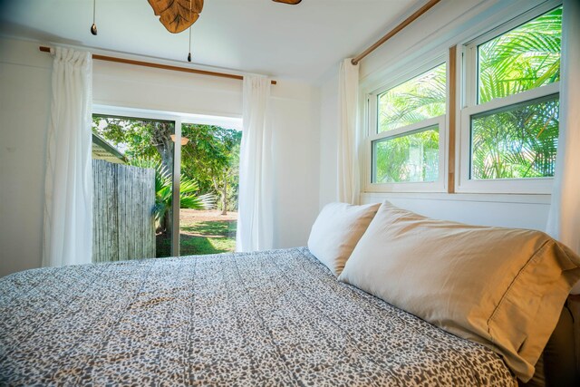 bedroom featuring ceiling fan and multiple windows