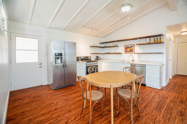 kitchen featuring vaulted ceiling with beams, dark hardwood / wood-style floors, sink, and stainless steel appliances