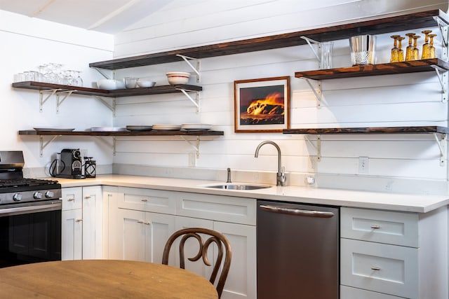 kitchen with white cabinets, lofted ceiling, sink, and appliances with stainless steel finishes