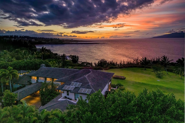 aerial view at dusk with a water view