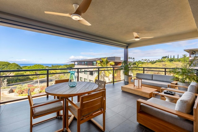 balcony with outdoor lounge area and ceiling fan