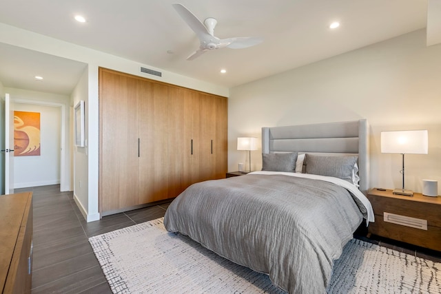 bedroom with ceiling fan and dark hardwood / wood-style floors