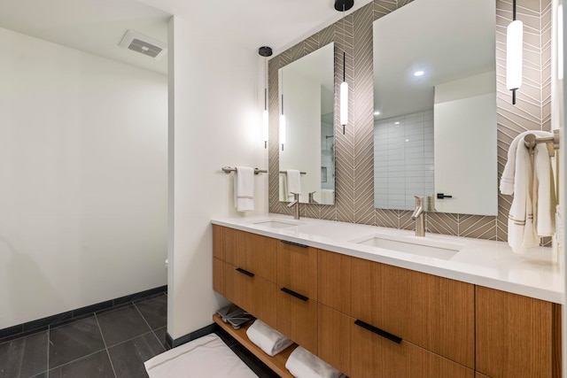 bathroom with tasteful backsplash, a shower, tile patterned flooring, and vanity