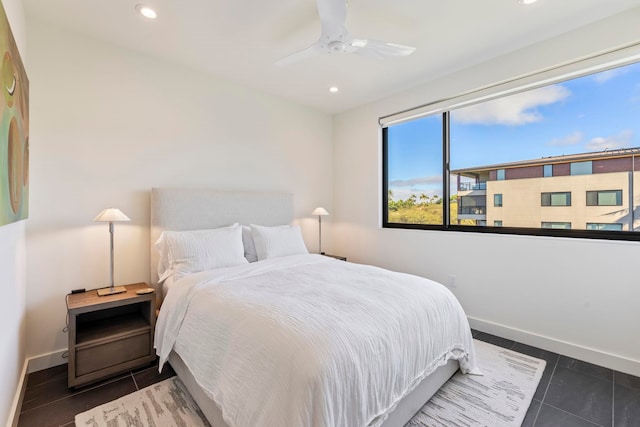 bedroom with ceiling fan and dark tile patterned flooring