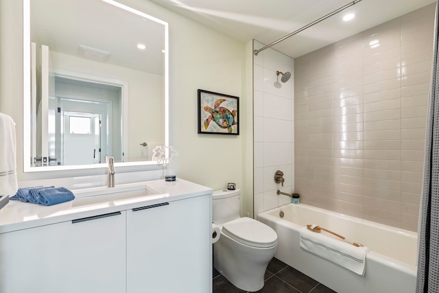 full bathroom with tile patterned floors, shower / bath combo, toilet, and vanity