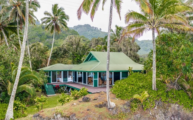 rear view of house featuring a mountain view