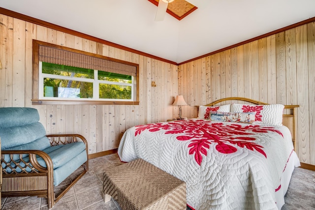 bedroom with ceiling fan and wood walls