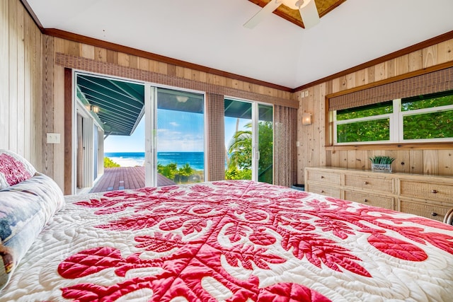 bedroom with access to exterior, wooden walls, a water view, and ceiling fan