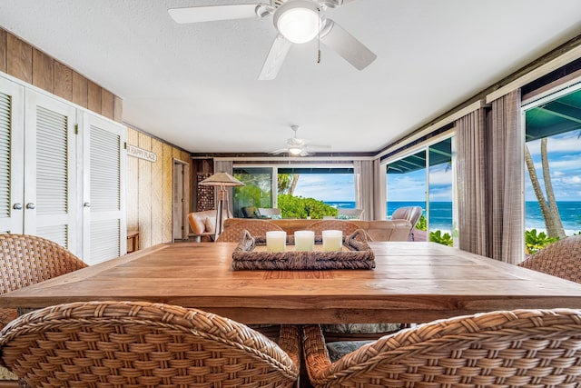 sunroom featuring a water view