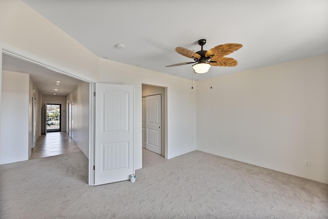 carpeted spare room featuring ceiling fan