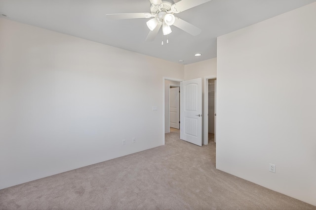 spare room with light carpet and ceiling fan