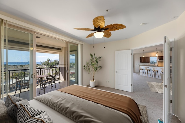 carpeted bedroom with access to exterior, a mountain view, and sink