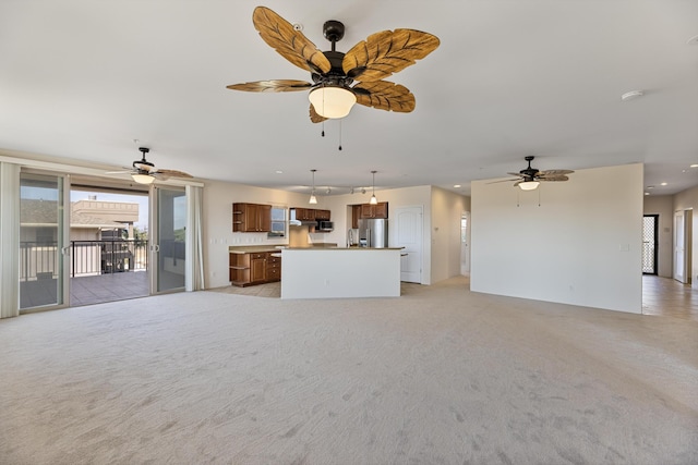 unfurnished living room with light carpet and ceiling fan