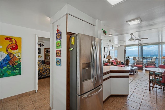70 Hauoli St Unit 217, Wailuku, HI 96793 - kitchen with stainless steel refrigerator with ice dispenser, a peninsula, ceiling fan, white cabinets, and open floor plan