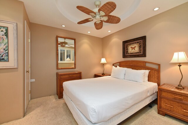 bedroom featuring light carpet and ceiling fan