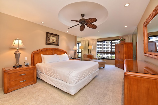 bedroom with ceiling fan and light colored carpet