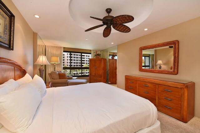 bedroom featuring light colored carpet and ceiling fan