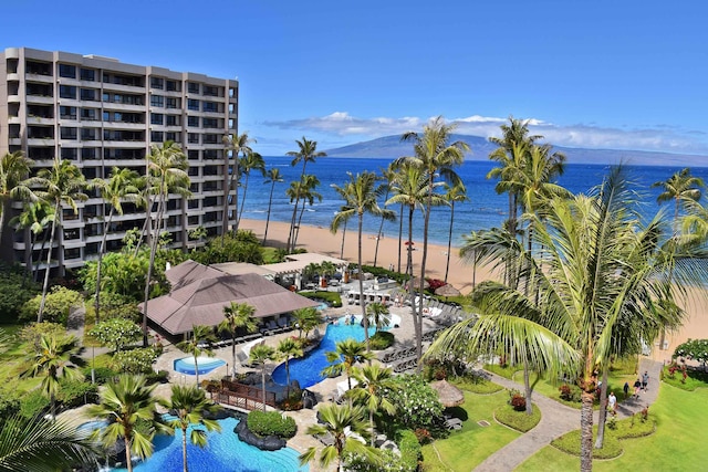 birds eye view of property with a water view and a view of the beach