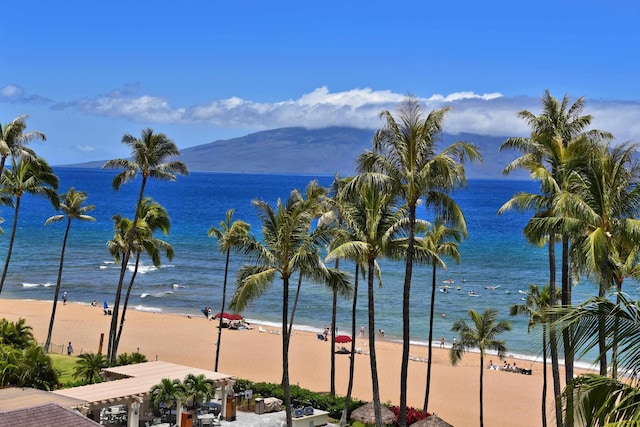 view of water feature with a beach view and a mountain view