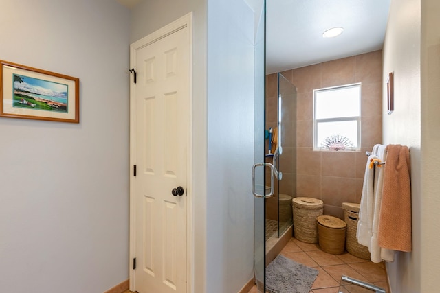 full bathroom with a stall shower and tile patterned flooring