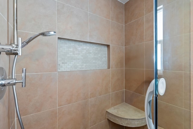 bathroom with tiled shower