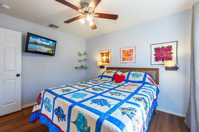 bedroom featuring visible vents, ceiling fan, baseboards, and wood finished floors