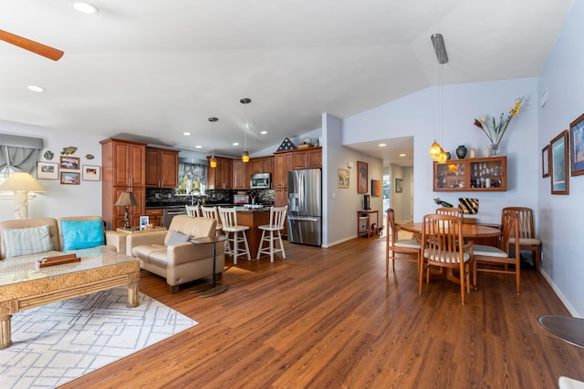 living area with vaulted ceiling, dark wood-style floors, and recessed lighting