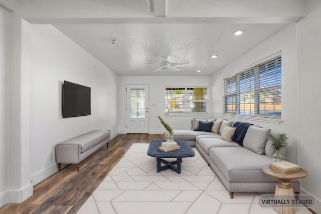 living room featuring a wealth of natural light, ceiling fan, and light hardwood / wood-style flooring